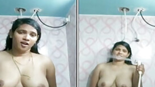 Indian girl with juicy melons satisfies pussy in the shower room