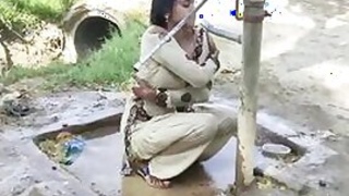 Young village girl taking a bath in a sari and caught on camera