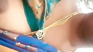 Daring aunt shows her tits in a moving two-wheeler